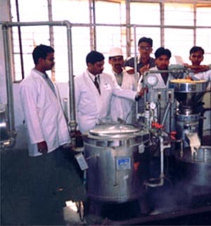 Suchi Soy technicians operating soy processing machinery